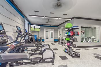A gym with treadmills, exercise balls, and dumbbells at Crabtree Lakeside Apartments, Raleigh, NC